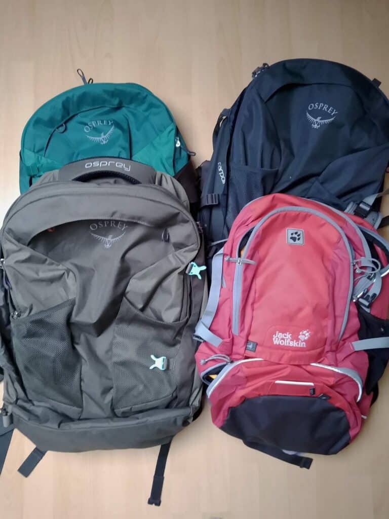 drei-osprey-rucksaecke-und-ein-roter-rucksack